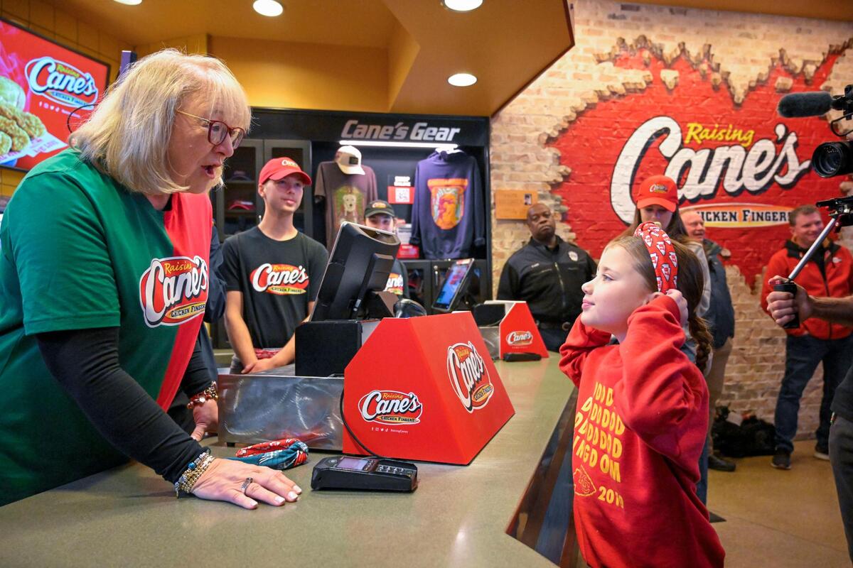 Donna Kelce spoke with Ella Jo Jasso, 7, of Kansas City, as she “worked” a shift at Raising Cane’s on Monday in Overland Park. Kelce told Ella Jo not to let anyone tell her she couldn’t be whatever she wanted to be in life.