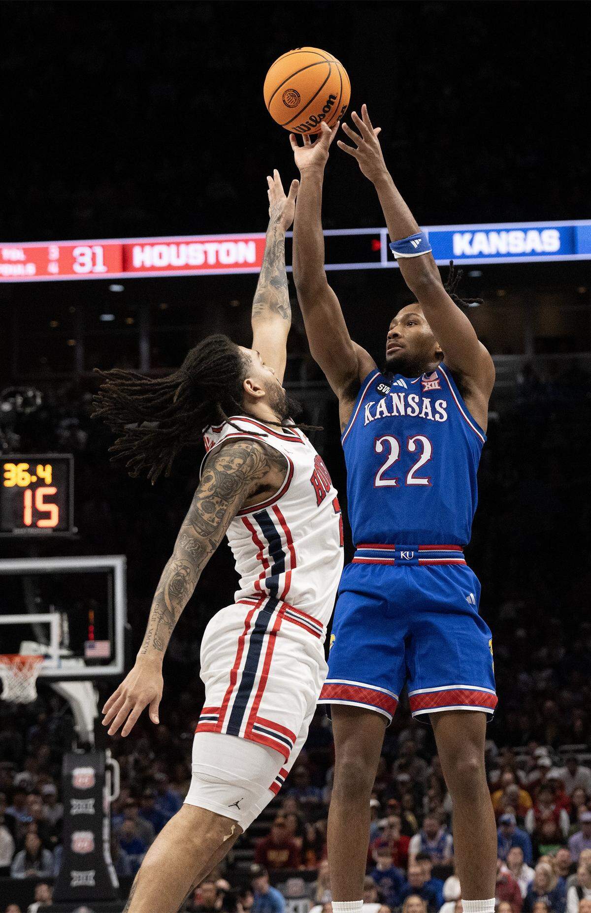 Kansas Jayhawks guard Darryn Peterson (22) shoots as Houston Cougars guard Emanuel Sharp (21) defends in the first half at the Big 12 Men's Basketball Tournament at T-Mobile Center on Friday, March 13, 2026, in Kansas City.