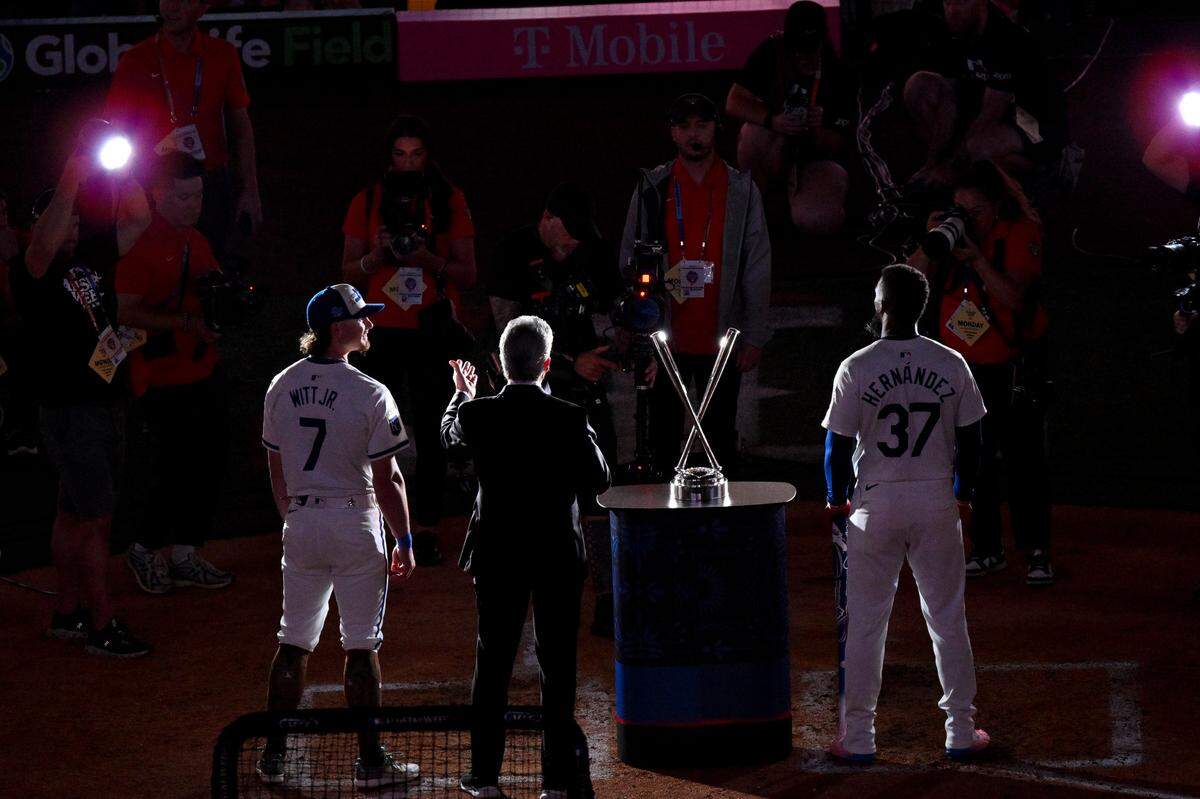 Royals shortstop Bobby Witt Jr. and L.A. Dodgers outfielder Teoscar Hernandez flank the trophy awarded the winner of the 2024 Home Run Derby on Monday night at Globe Life Field in Arlington, Texas. Hernandez beat Witt by one homer in the final round of the leadup event to Tuesday’s All-Star Game.