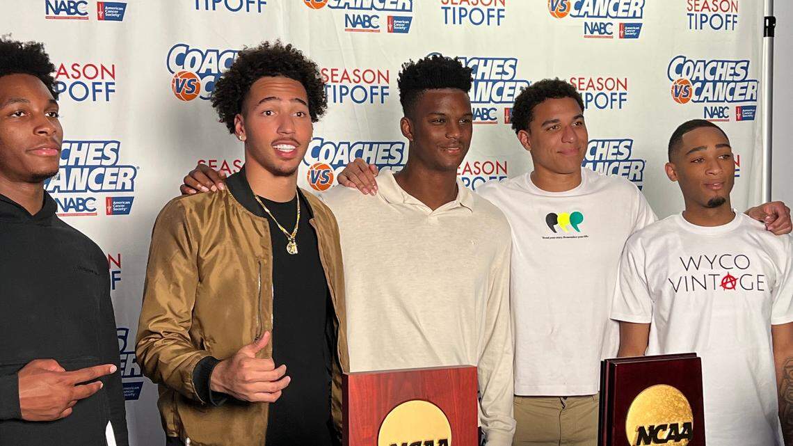 Kansas Jayhawks basketball players (from left to right) MJ Rice, Jalen Wilson, KJ Adams, Kevin McCullar and Dajuan Harris pose in front of hardware at Wednesday’s charity event in Lawrence