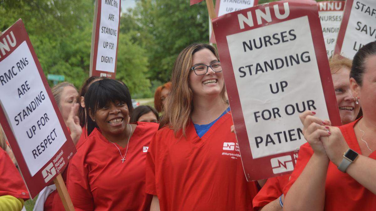 Chimel Howard (left) of Houston and Shannon Beattie (center) of Florida joined nurses at Research Medical Center during a picket in June. Nurses at Research, Menorah Medical Center in Overland Park and 13 other HCA hospitals in three states are now threatening to strike.