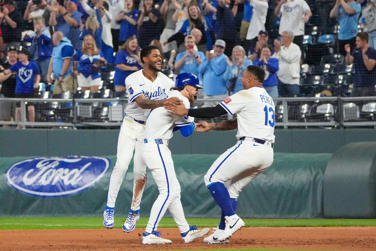 Kansas City Royals shortstop Bobby Witt Jr. (7) celebrates with second base Maikel Garcia (11) and designated hitter Salvador Perez (13) after a walk-off win over the Chicago White Sox at Kauffman Stadium on May 6, 2025 in Kansas City, Missouri, USA.