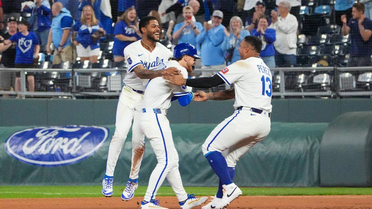 Kansas City Royals shortstop Bobby Witt Jr. (7) celebrates with second base Maikel Garcia (11) and designated hitter Salvador Perez (13) after a walk-off win over the Chicago White Sox at Kauffman Stadium on May 6, 2025 in Kansas City, Missouri, USA.