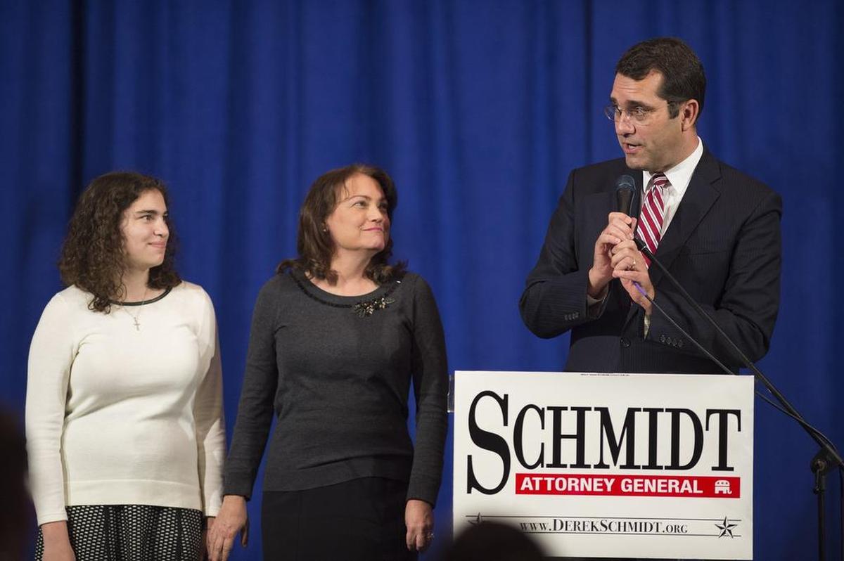 With his daughter and wife, Jennifer Schmidt, at his side, Republican Derek Schmidt, incumbent candidate for Kansas Attorney General, addressed the crowd Tuesday at a Johnson County Republican Party general election watch party in Overland Park.