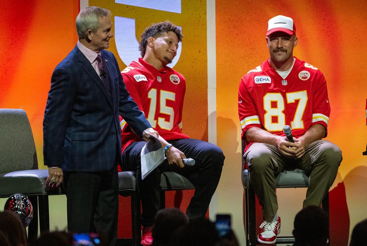 Chiefs announcer Mitch Holthus, from left, Kansas City Chiefs quarterback Patrick Mahomes (15) and tight end Travis Kelce (87), sit on stage during the 2024 Chiefs Kickoff Luncheon.