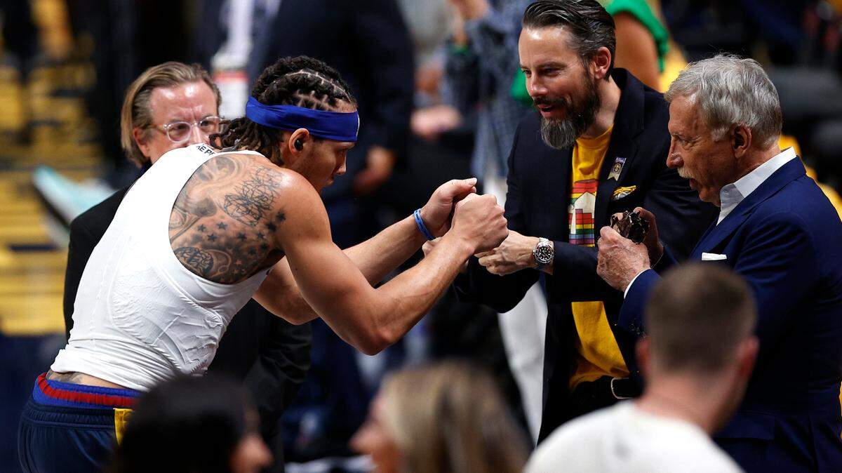 Denver Nuggets forward Aaron Gordon (left) fist bumps owner Stan Kroenke and vice chairman Josh Kroenke before the game against the Miami Heat in Game 1 of the 2023 NBA Finals at Ball Arena.