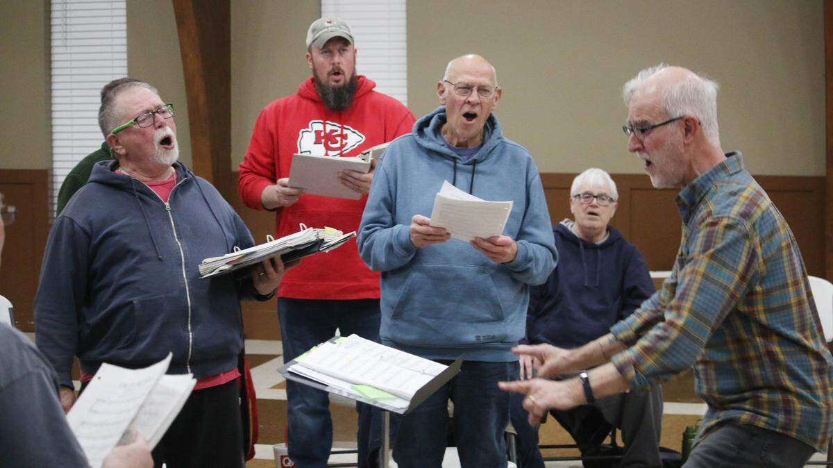 Gus Wolf, Tim McWilliams, Steve Chellgren and Mark Perry follow the direction of Randy Schott during a rehearsal of the Trails West Chorus.