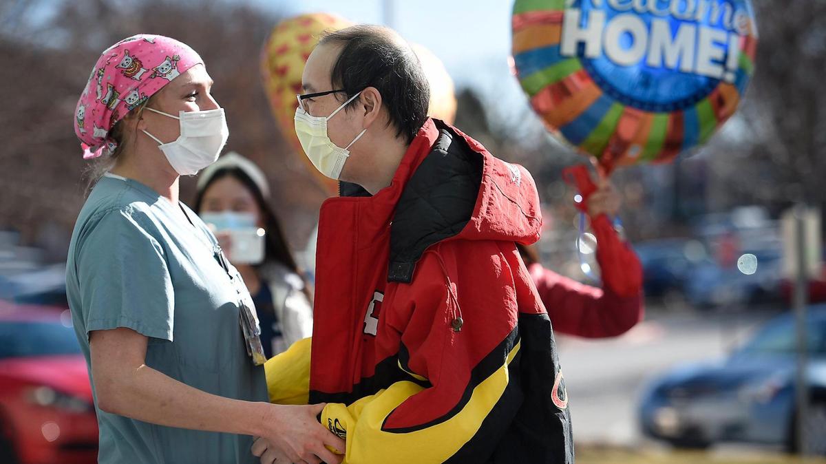 Registered Nurse Katie Hanrahan greets COVID-19 survivor Toan Nguyen as he was being discharged in January from Research Medical Center in Kansas City after nearly four-month battle with the coronavirus. The weekly average of new coronavirus cases in the Kansas City metro area continues to fall.