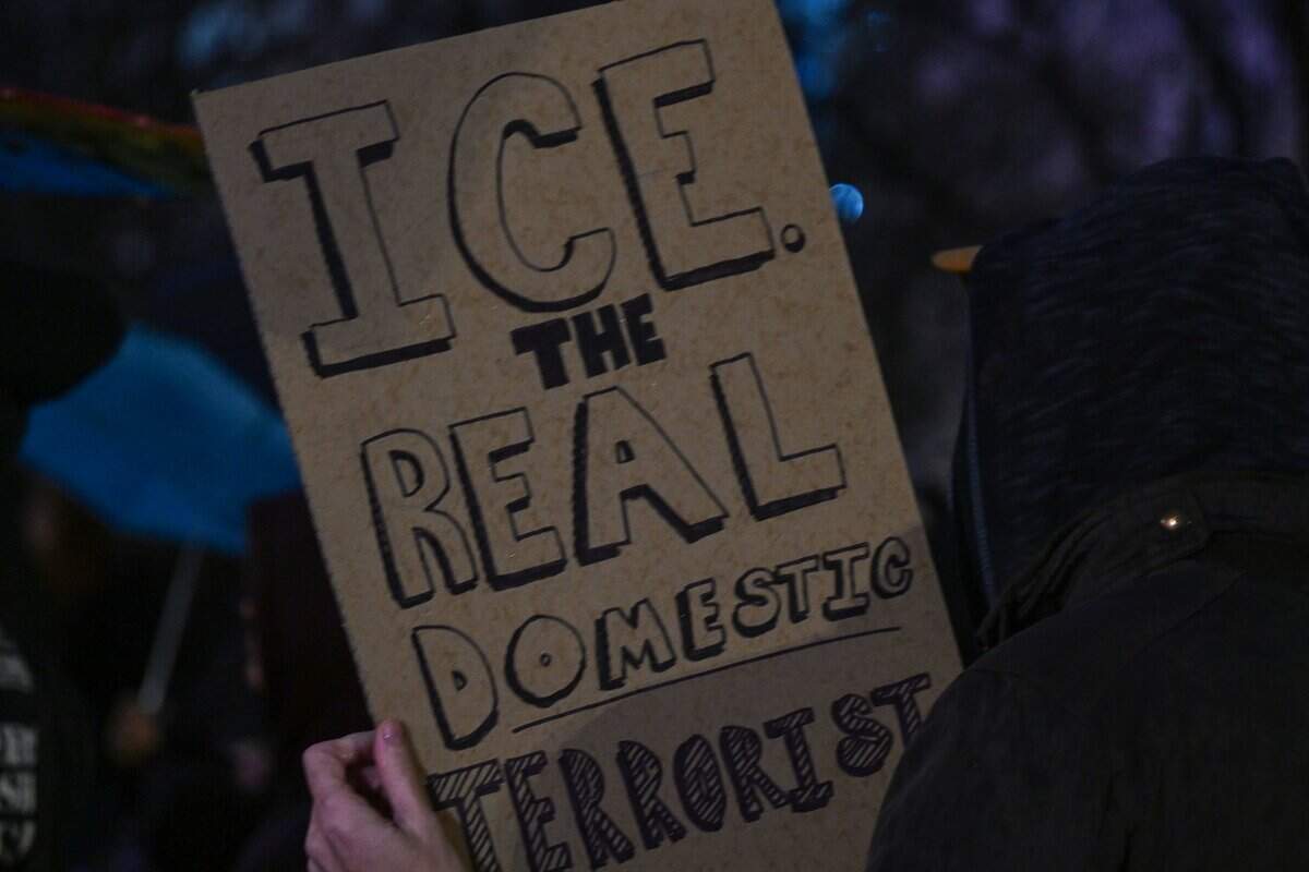 A person holds up a sign as crowds rally against ICE outside City Hall in Kansas City on Thursday, Jan. 8. An ICE agent shot and killed Renee Good, a former KC resident, in Minneapolis on Wednesday, Jan. 7.