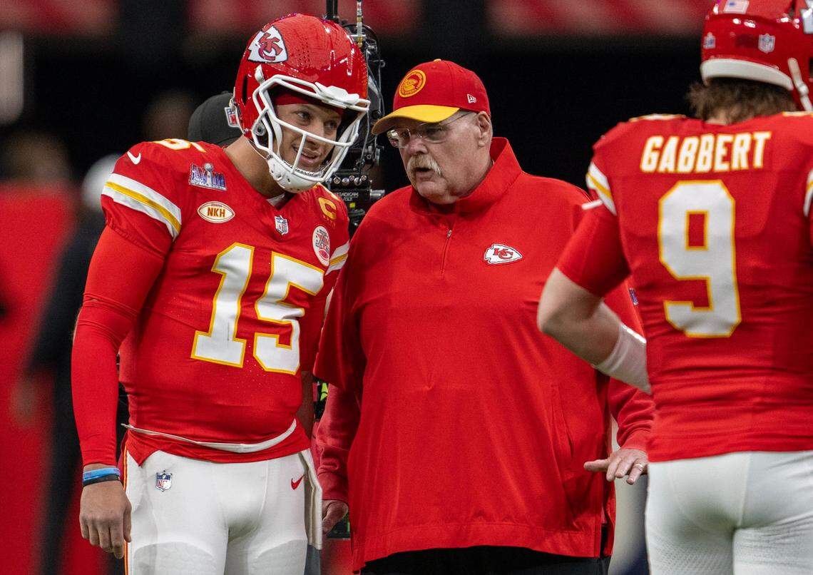 Kansas City Chiefs quarterback Patrick Mahomes, left, confers with coach Andy Reid before the start of Super Bowl LVIII in Las Vegas.