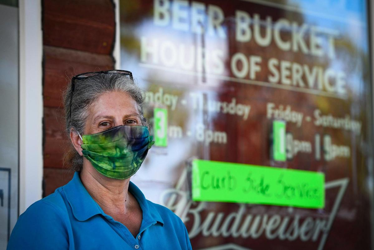 Logan, Kansas, resident Candice Hasselbach works at the Beer Bucket liquor store and the Hometown Market grocery store in the northwest Kansas town. Hasselbach is a big proponent of wearing masks to prevent the spread of the coronavirus.