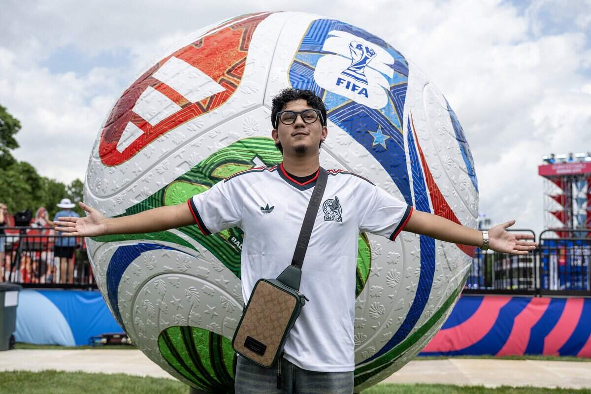Jair Mijares poses for a portrait next to a soccer ball sculpture during the FIFA Fan Festival on Thursday, June 11, 2026, in Kansas City.
