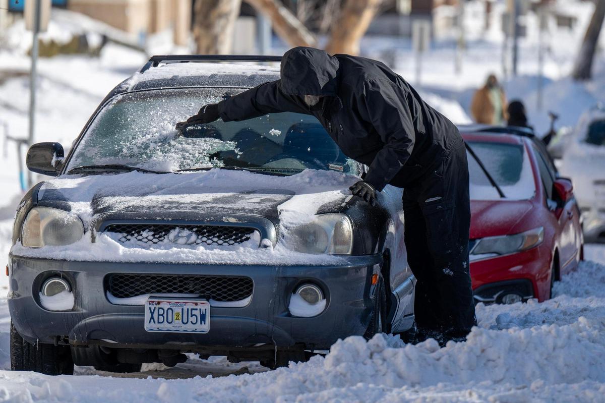 A resident removes ice from their vehicle’s windshield on Monday, Jan. 6, 2025, in Kansas City.