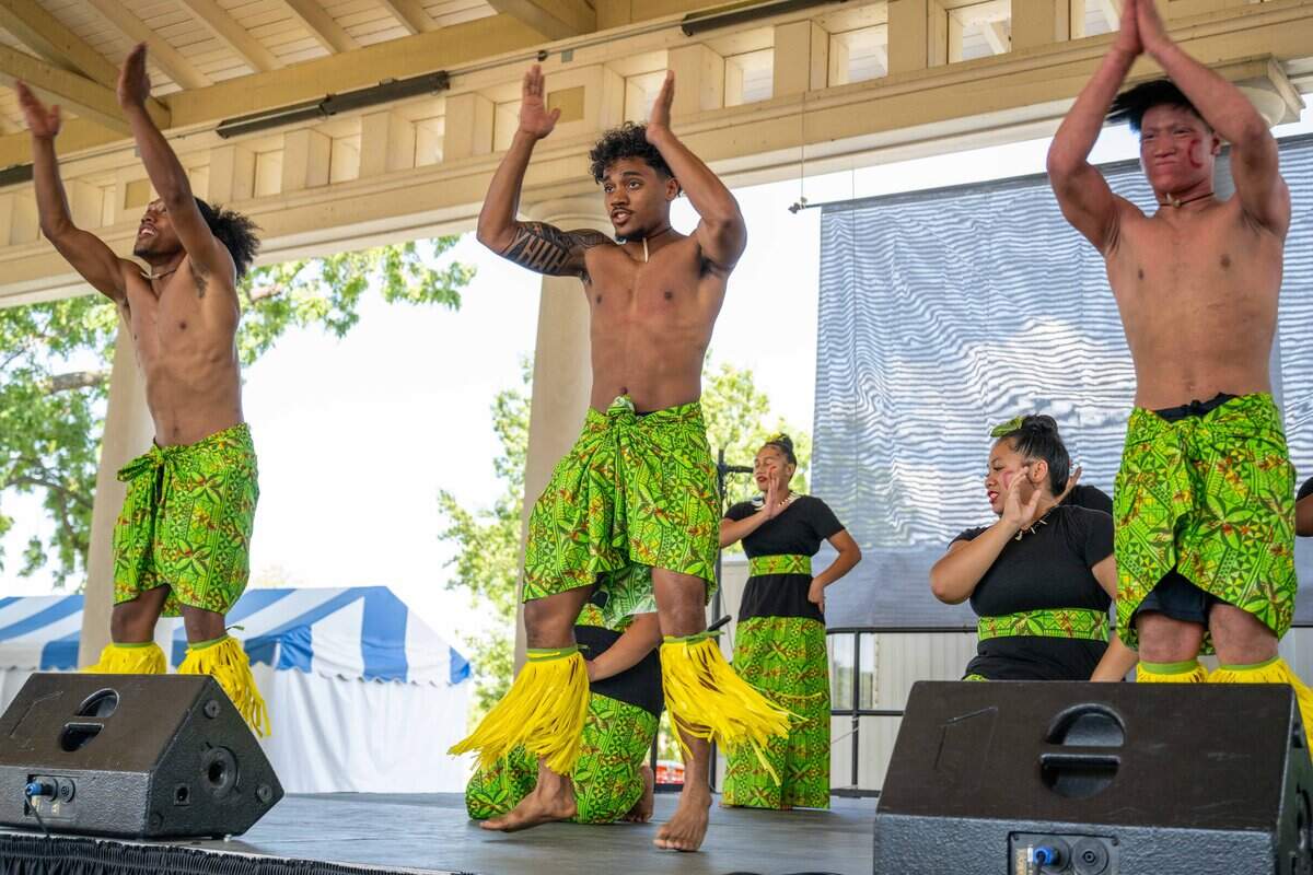 Young men perform a traditional Samoan dance at the Ethnic Enrichment Festival in Swope Park on Saturday, Aug. 16, 2025, in Kansas City. The annual festival celebrates the many different cultures and ethnicities that exist in Kansas City, with vendor booths, cultural education opportunities, and performances. Temperatures reached nearly 100 degrees.