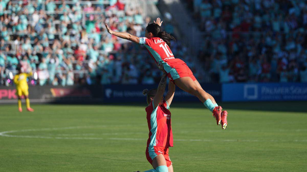 Kansas City Current midfielder Lo’eau LaBonta (10) celebrates a goal with defender Hailie Mace (4) in the second half against the Seattle Reign FC at CPKC Stadium on June 9, 2024.
