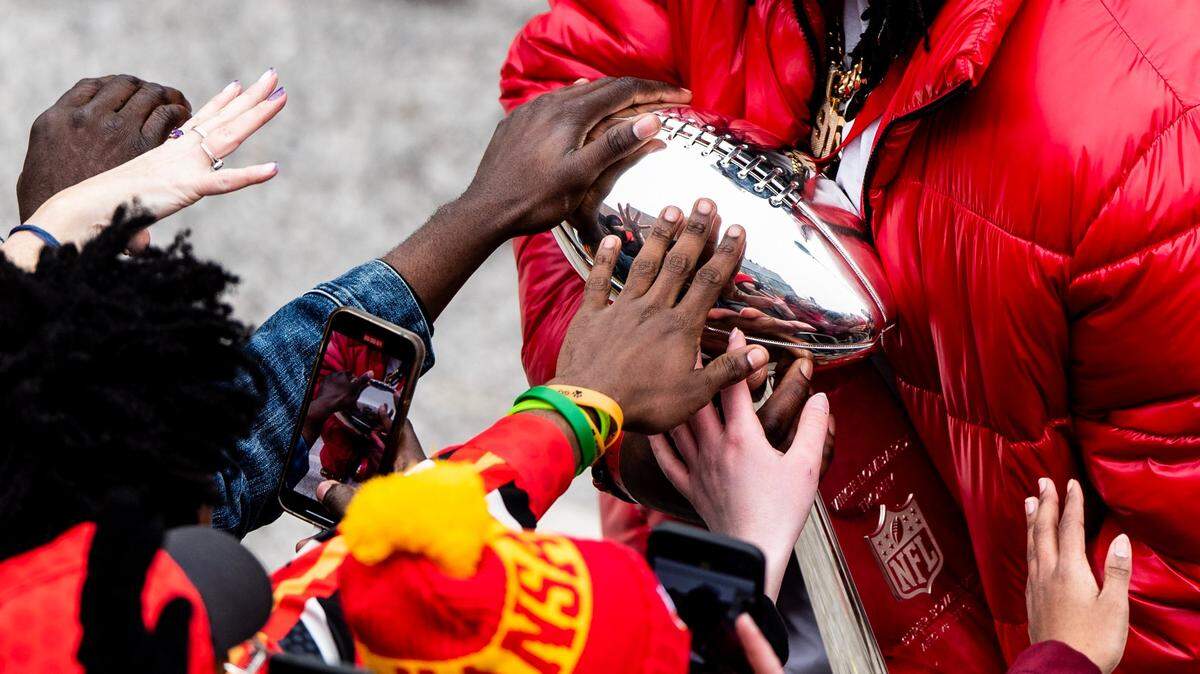 Kansas City Chiefs defensive tackle Derrick Nnadi lets fans touch the Vince Lombardi Trophy during the Kansas City Chiefs Super Bowl victory parade on Wednesday, Feb. 15, 2023, in Kansas City.