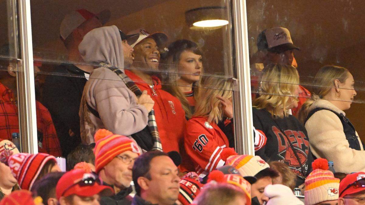 Taylor Swift watched Sunday’s Chiefs-Bills game in a suite full of friends and family of new boyfriend Travis Kelce, including one of his longtime friends from Ohio, Aric Jones, seen here next to her.