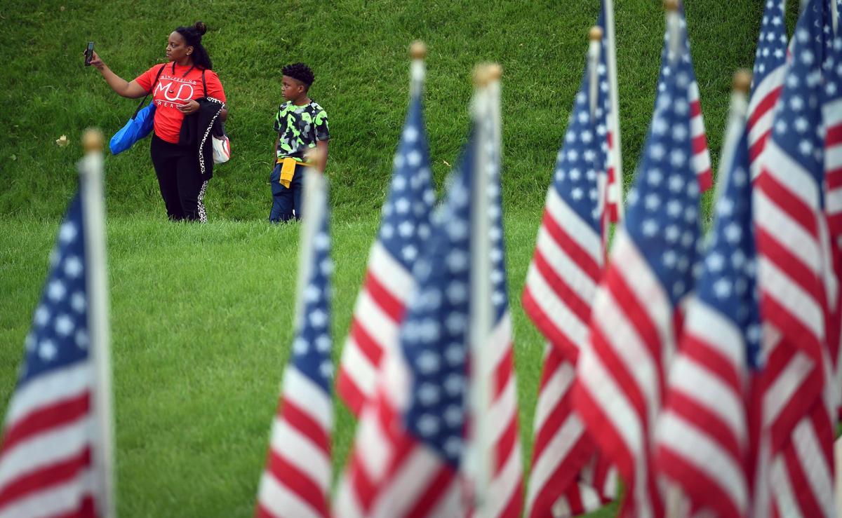 Visitors viewed Flags of the Forgotten Soldiers, a tribute to veterans lost to suicide, which were on display at the National World War I Museum and Memorial on Sunday, May 30, in Kansas City. The museum was hosting the inaugural Great Balloon Glow which brought thousands of visitors to the Liberty Memorial for the event.