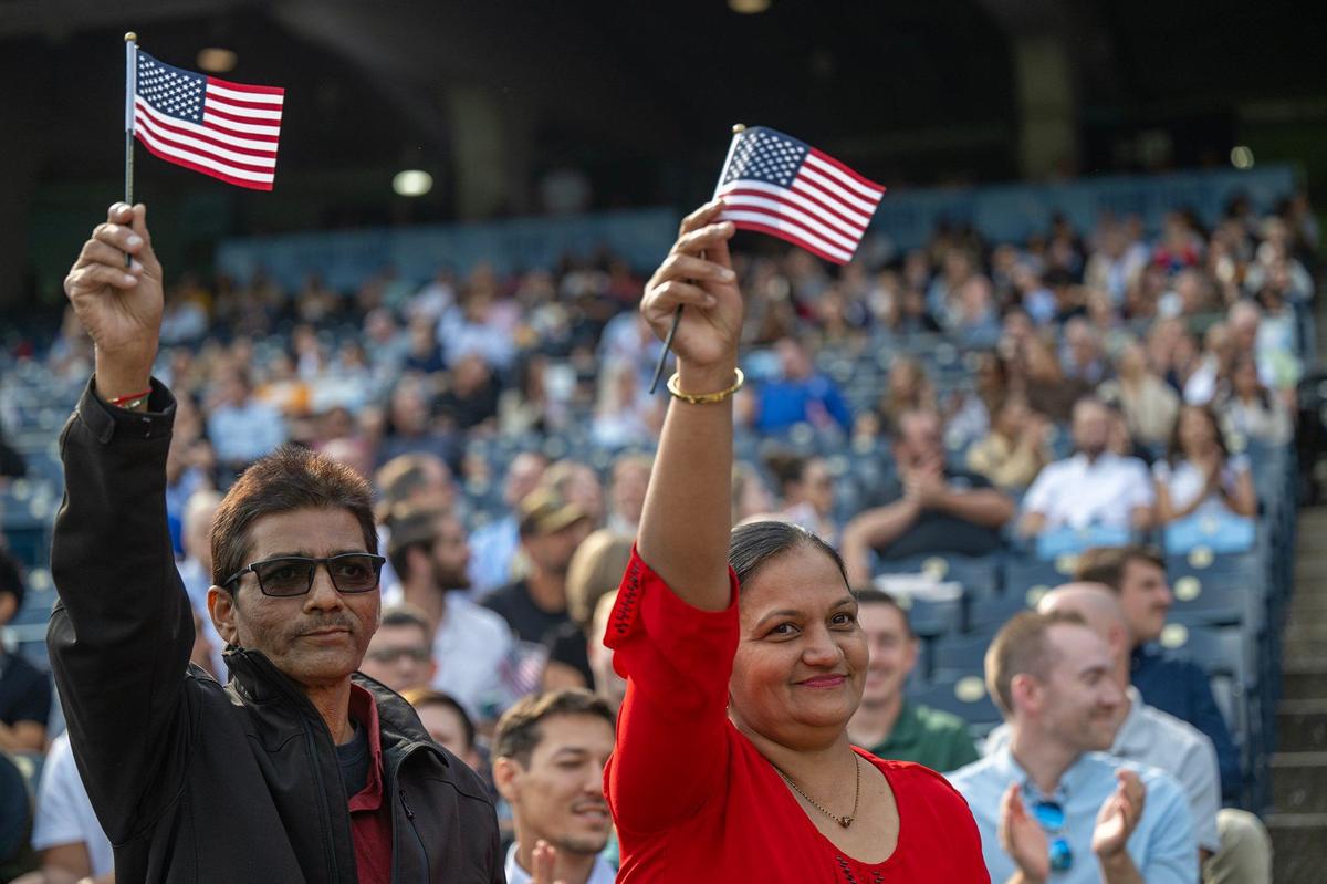 Dipakbhai Patel, left, and his wife, Pritibala Dipakbhai Patel, natives of India, proudly stand as their country was recognized before the pair took the Oath of Allegiance Thursday. The couple live in Branson, Missouri and work in the tourism industry. They’ve waiting five years to become U.S. citizens.