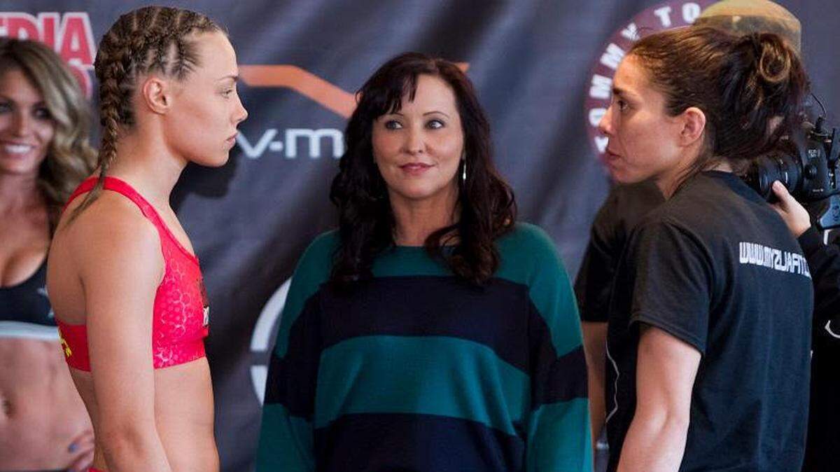 Fighter Rose Namajunas, left, stares down Kathina Lowe during a weigh-in as Shannon Knapp looks on.