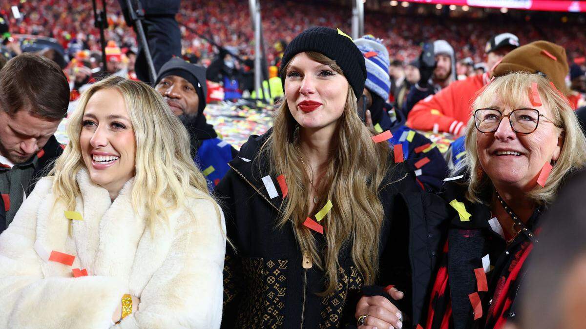 Recording artist Taylor Swift (center) Brittany Mahomes (left) and Donna Kelce (right) react after the AFC Championship game against the Buffalo Bills at GEHA Field at Arrowhead Stadium.