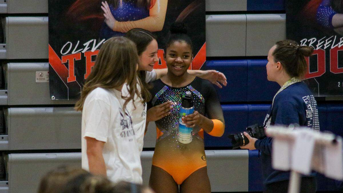 Darcel Carter, 14, a freshman at Shawnee Mission Northwest High School, is embraced by teammates during the state championships Oct. 25, 2025.