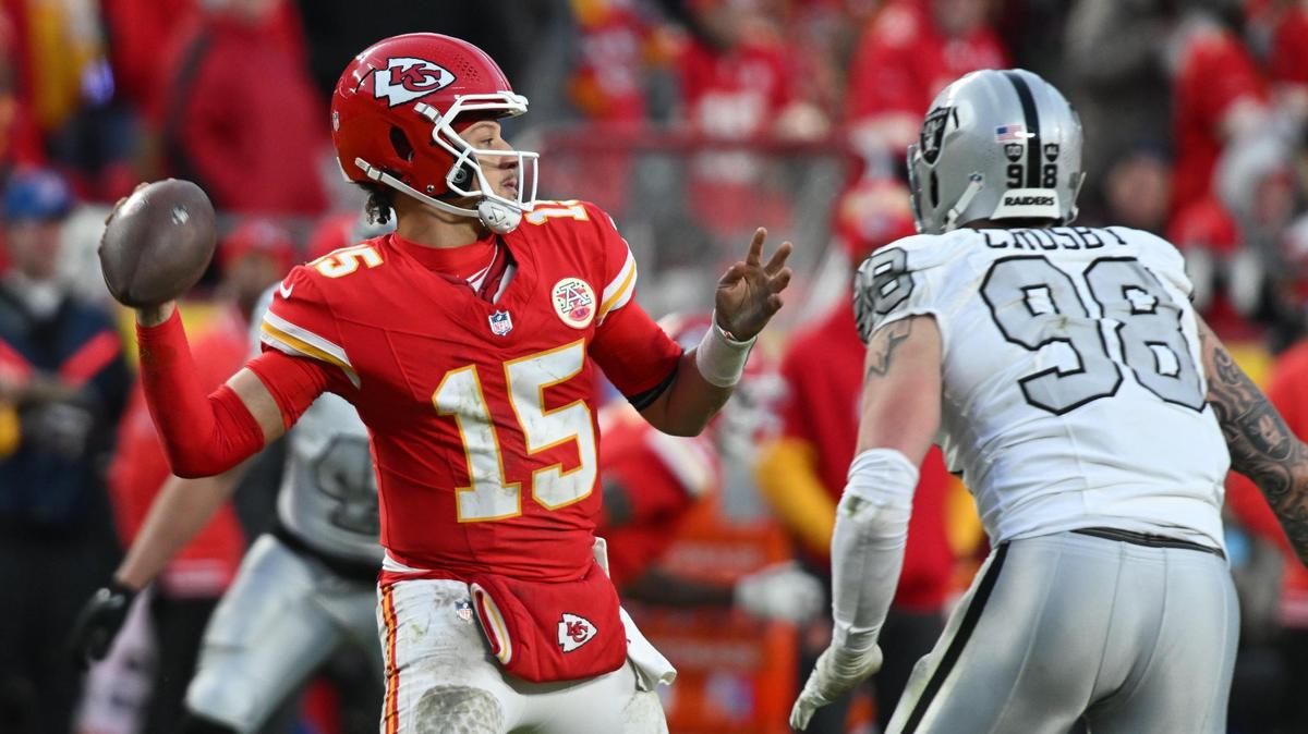 Kansas City Chiefs quarterback Patrick Mahomes (15) throws a pass while being pressured by Las Vegas Raiders defensive end Maxx Crosby (98) on Friday, Nov. 29, 2024, at GEHA Field at Arrowhead Stadium.