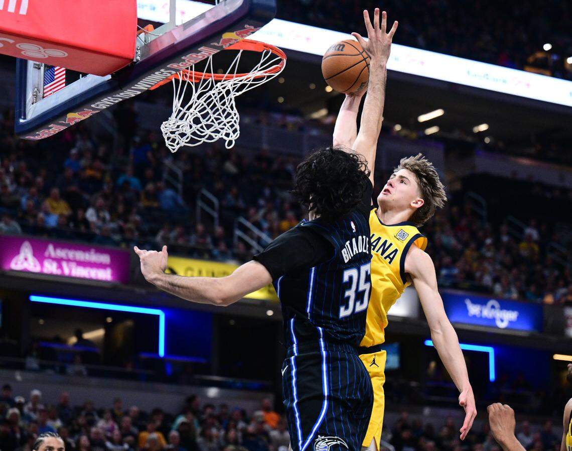 Indiana Pacers forward Johnny Furphy (12) dunks the ball over Orlando Magic center Goga Bitadze (35) during the second quarter at Gainbridge Fieldhouse on April 11, 2025.