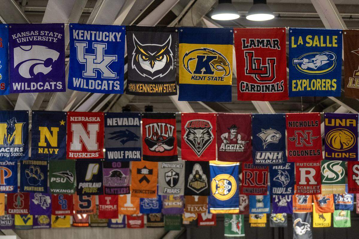 College banners hang from the rafters during the&nbsp;Triple Crown NIT, an elite-level youth volleyball tournament, at Bartle Hall on Sunday, Feb. 15, 2026, at the&nbsp;Kansas City Convention Center. More than 1,000 scouts were attending the four-day event. 