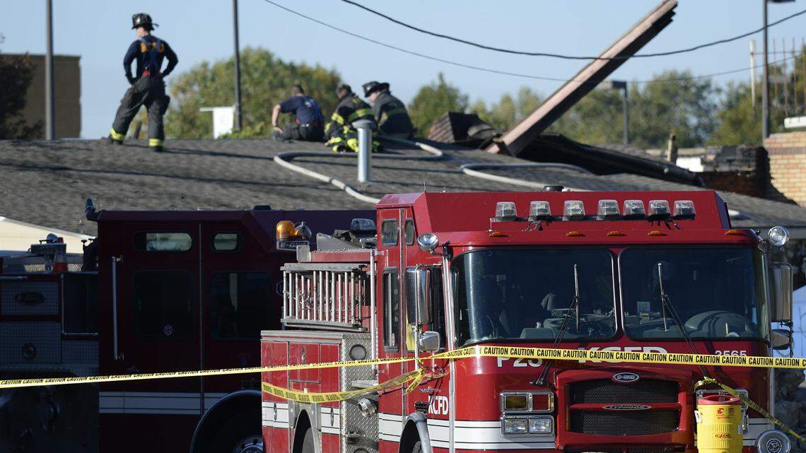 Pumper 23 (foreground) and pumper 10 were at the scene with firefighters Wednesday morning as they continued to work on the building where two firefighters from those stations were killed Monday night. 