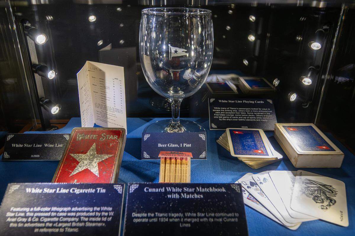 White Star Line glassware, playing cards, matches, and other artifacts are displayed at the Titanic: An Immersive Voyage exhibit at Union Station on Thursday, Nov. 6, 2025, in Kansas City.