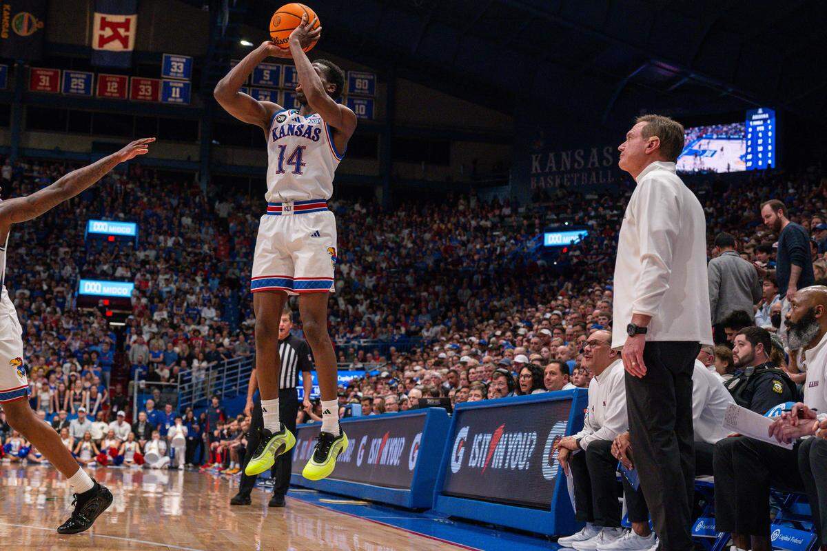 Kansas Jayhawks guard Melvin Council Jr. (14) rises up for a 3-point shot as head coach Bill Self looks on in the second half vs. the Arizona Wildcats on Monday, February 9, 2026, at Allen Fieldhouse.