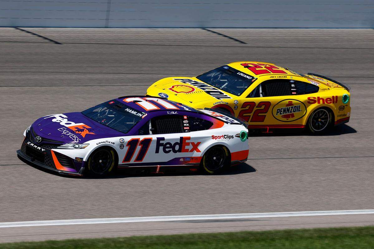 NASCAR Cup Series drivers Denny Hamlin (No. 11) and Joey Logano (No. 22) spar late during Sunday’s AdventHealth 400 at Kansas Speedway in Kansas City, Kan.