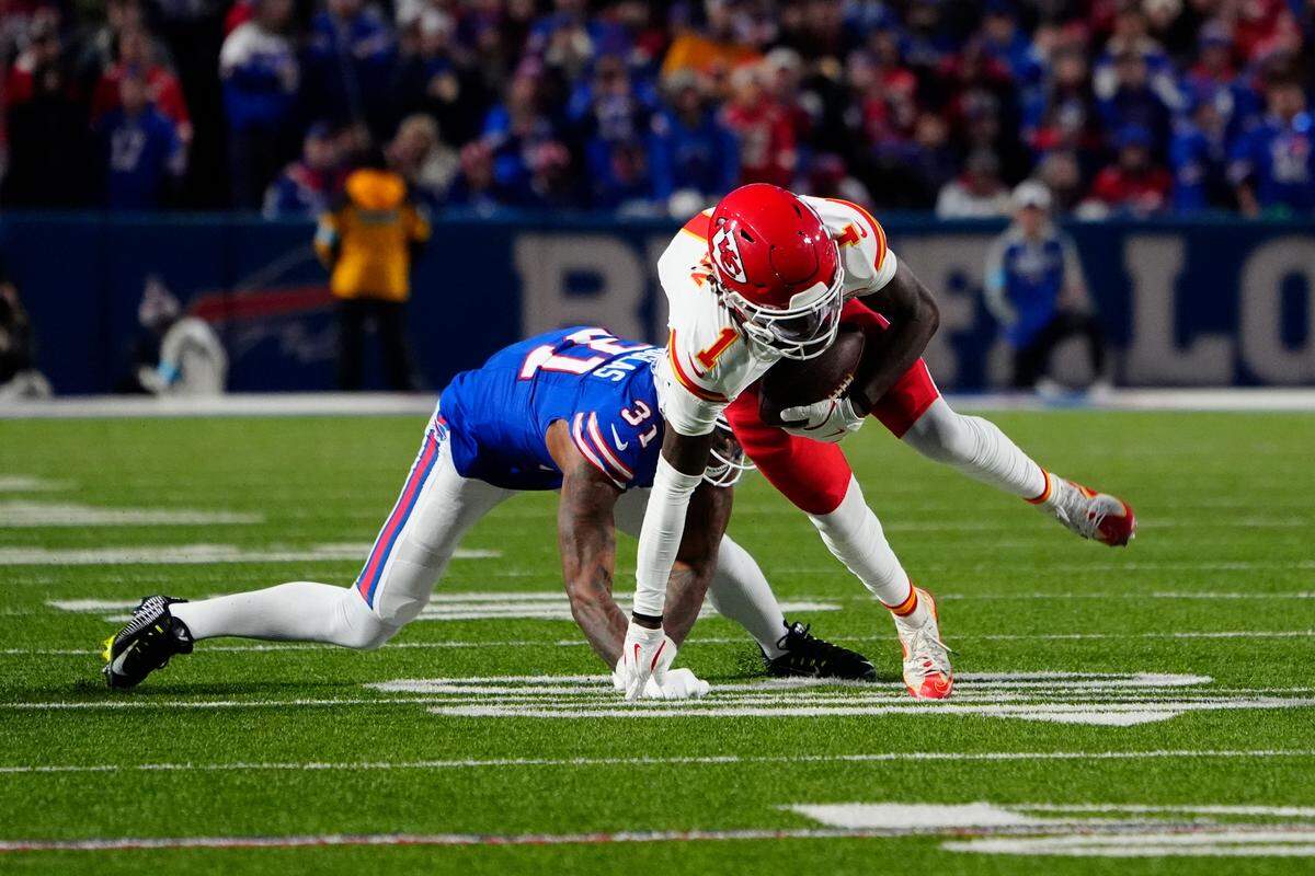 Kansas City Chiefs wide receiver Xavier Worthy (1) makes a catch against Buffalo Bills cornerback Rasul Douglas (31) during the first half at Highmark Stadium.