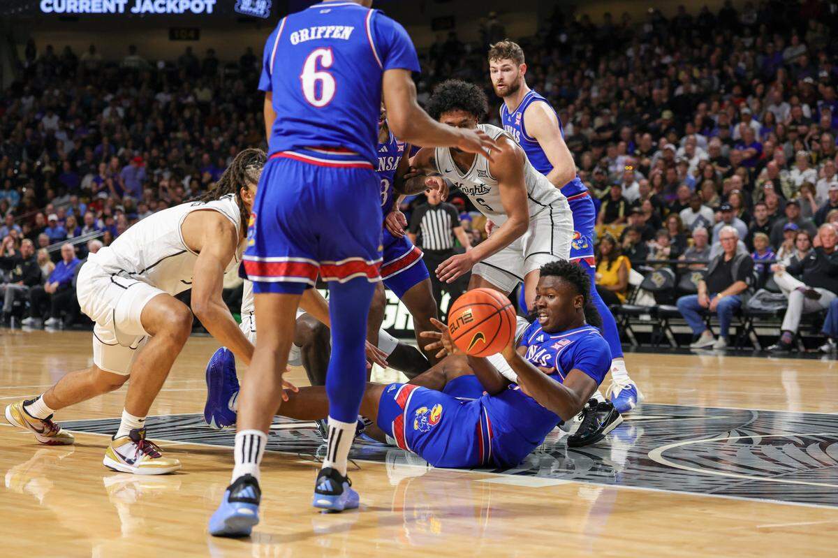Kansas Jayhawks forward Flory Bidunga (No. 40, on the floor) recovers a loose ball against the UCF Knights during a Sunday, Jan. 5, 2025 men’s college basketball game at Addition Financial Arena in Orlando.