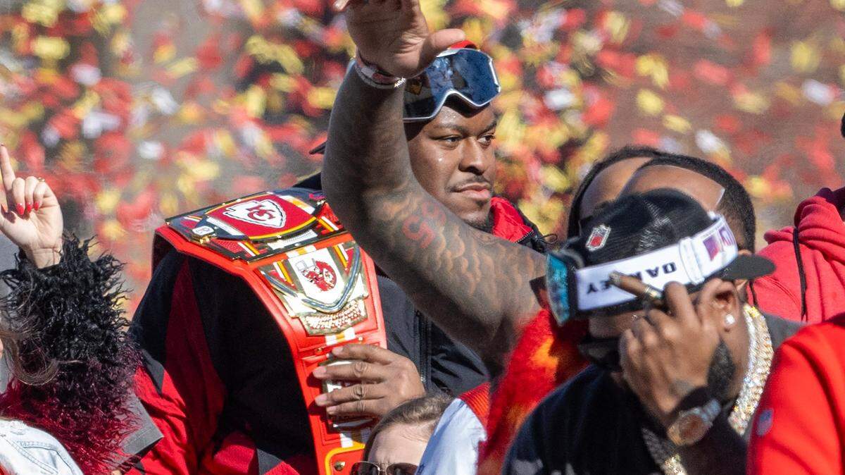 Kansas City Chiefs guard Trey Smith holds a Chiefs-themed WWE-style belt during the Chiefs Super Bowl LVIII victory parade on Wednesday, Feb. 14, 2024, in Kansas City, Missouri. Smith shared his belt to help calm a child who was upset after a shooting incident happened at Union Station in Kansas City moments after the Chiefs celebration ended.