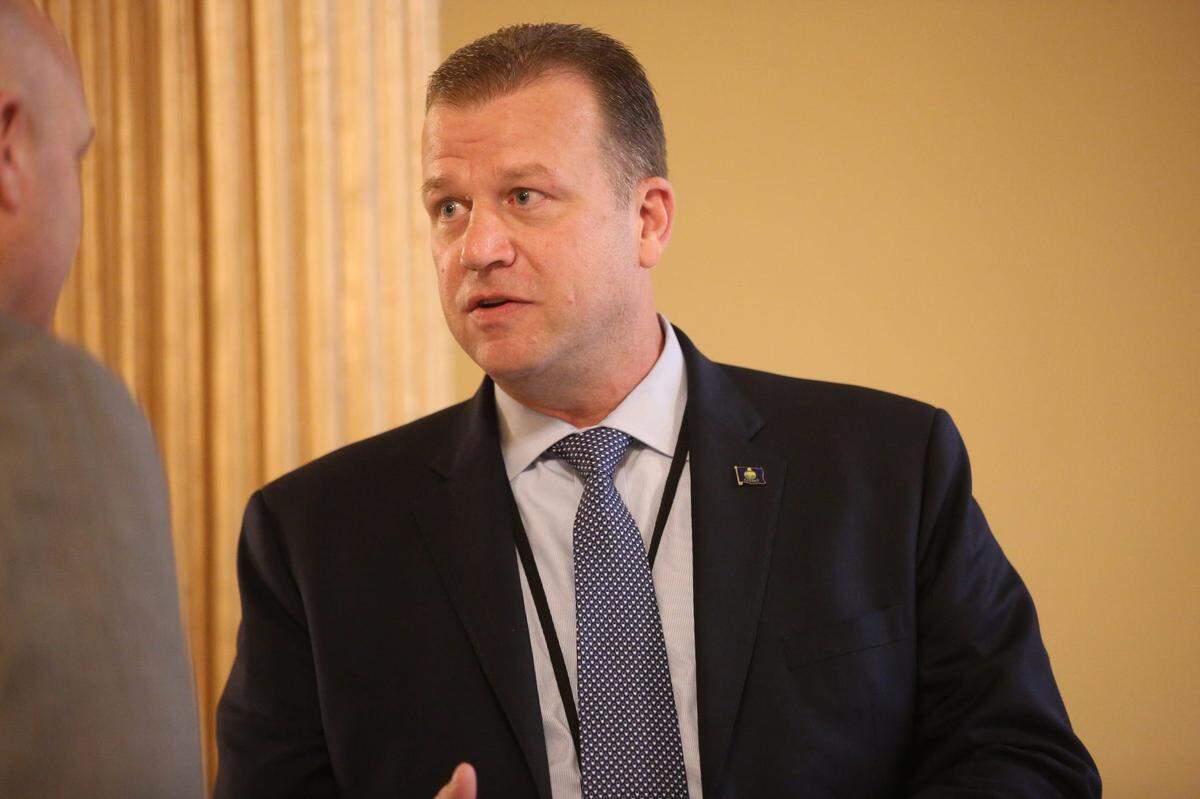 Acting Kansas Highway Patrol Superintendent Erik Smith converses after his confirmation hearing before the Senate Confirmation Oversight Committee Wednesday.