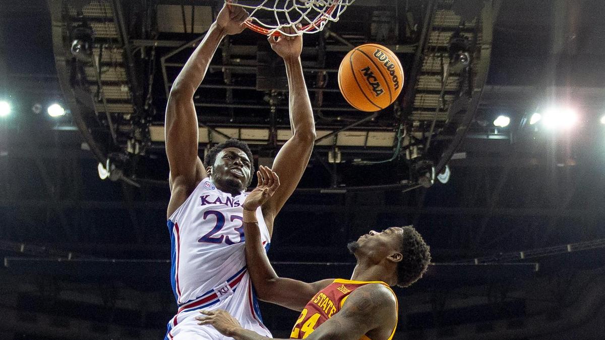 Kansas center Ernest Udeh Jr. (23) dunks over Iowa State forward Hason Ward (24) during a Big 12 Tournament semifinal game on March 10, 2023, in Kansas City.