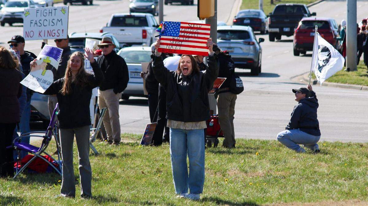 Abby Mathewson, 28, holds a sign and chants during the No Kings rally in Overland Park March 28, 2026.