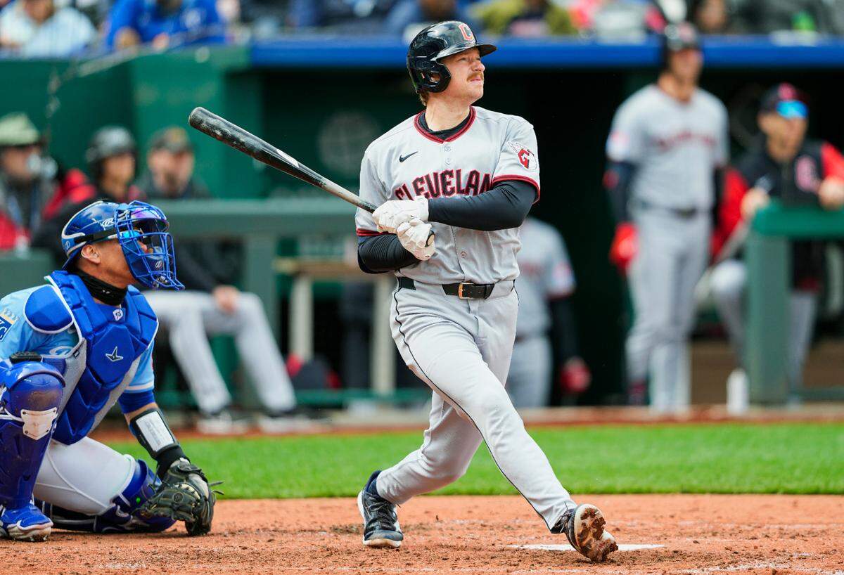 Cleveland Guardians designated hitter Kyle Manzardo hits a home run during the fifth inning of a game against the Kansas City Royals at Kauffman Stadium on Sunday, March 30, 2025.