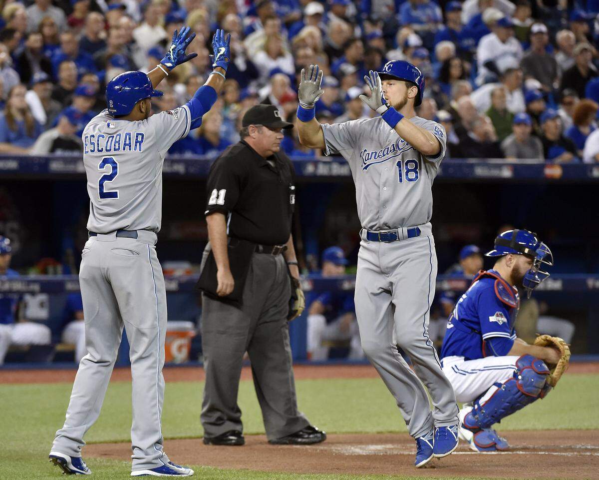 Kansas City Royals shortstop Alcides Escobar and second baseman Ben Zobrist met at home plate after Zobrist drove in Escobar on with a home run in the first inning during Tuesday’s ALCS baseball game on October 20, 2015 at Rogers Centre in Toronto.