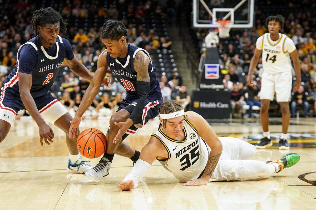 Missouri Tigers forward Noah Carter (No. 35) fights Jackson State’s Ken Evans Jr. (left) and Chase Adams for a loose ball during Sunday evening’s game at Mizzou Arena in Columbia.