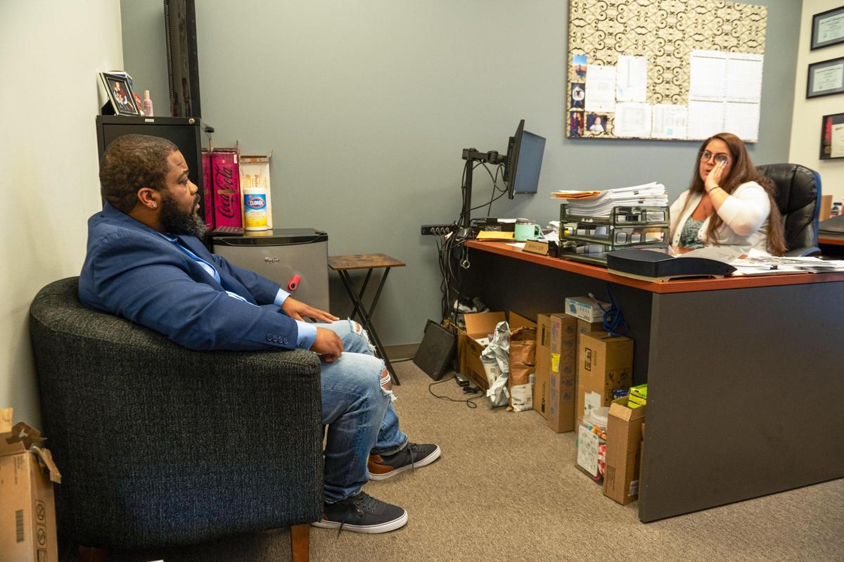 Hoping to find more employers for Dads Against Crime’s job placement services, Andre Harris, left, meets with Lindsey Weidenfeller, human resources manager at Weidenhammer New Packing.