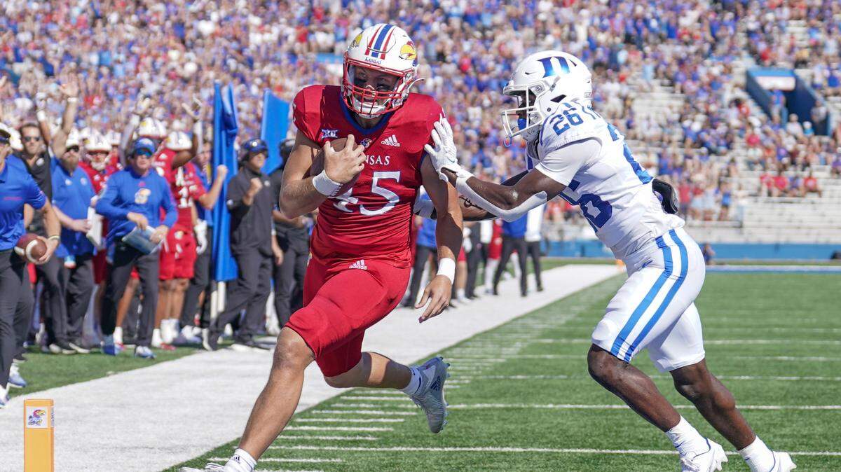 Kansas tight end Trevor Kardell (45) scores a touchdown as Duke defensive back Joshua Pickett (26) attempts a tackle during the game at David Booth Kansas Memorial Stadium on Sept. 24, 2022.