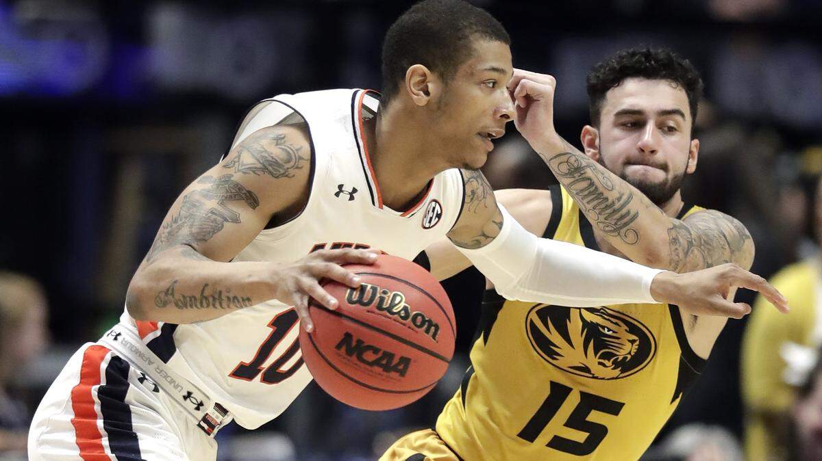 Auburn guard Samir Doughty (10) drives against Missouri guard Jordan Geist (15) in the first half of an NCAA college basketball game at the Southeastern Conference tournament Thursday, March 14, 2019, in Nashville, Tenn. (AP Photo/Mark Humphrey)