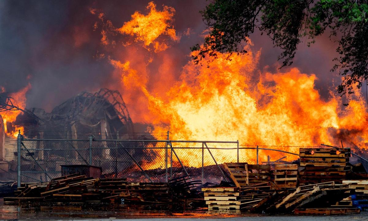 Flames engulf stacks of pallets at Pioneer Pallet in the 3500 block of Nicholson Ave. on Thursday, June 15, 2023, in Kansas City.