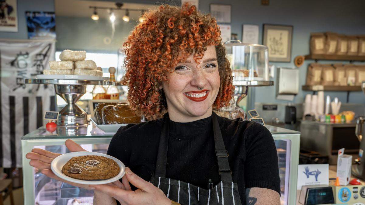 Pastry chef Nichole Taylor holds out one of her chocolate chip cookies on a small plate at Sister Anne's Coffee and Records Thursday, Dec. 4, 2025, in Kansas City.
