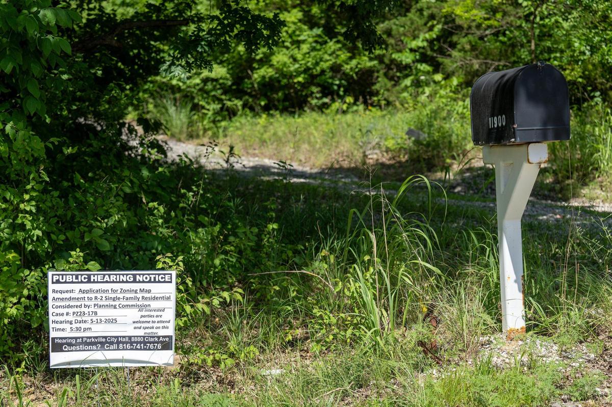 A public hearing notice sign remains near 11900 N. Crooked Rd., where a Prime Development is asking to rezone land for a high-end subdivision just west of The National Golf Club of Kansas City, in Parkville. 070825