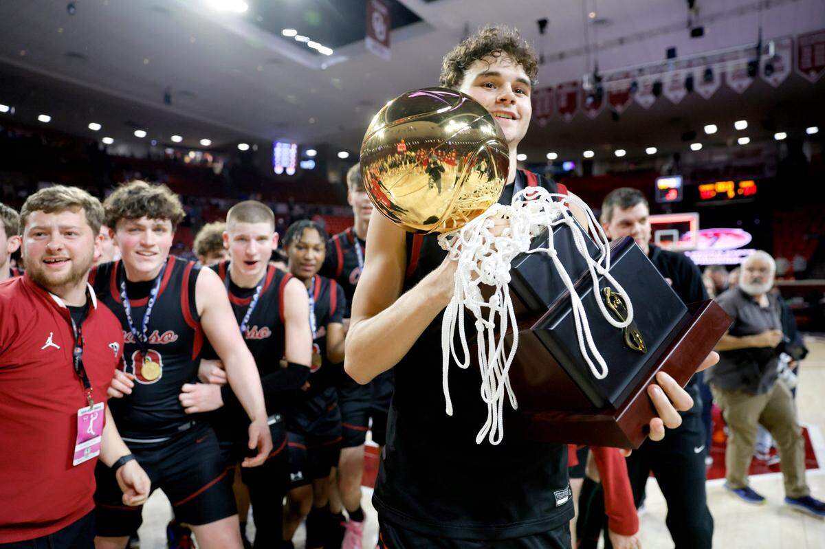 Owasso’s Jalen Montonati carries the trophy after the Class 6A boys high school basketball state tournament championship game between Edmond North and Owasso at Lloyd Noble Center in Norman, Okla., Saturday, March 9, 2024.