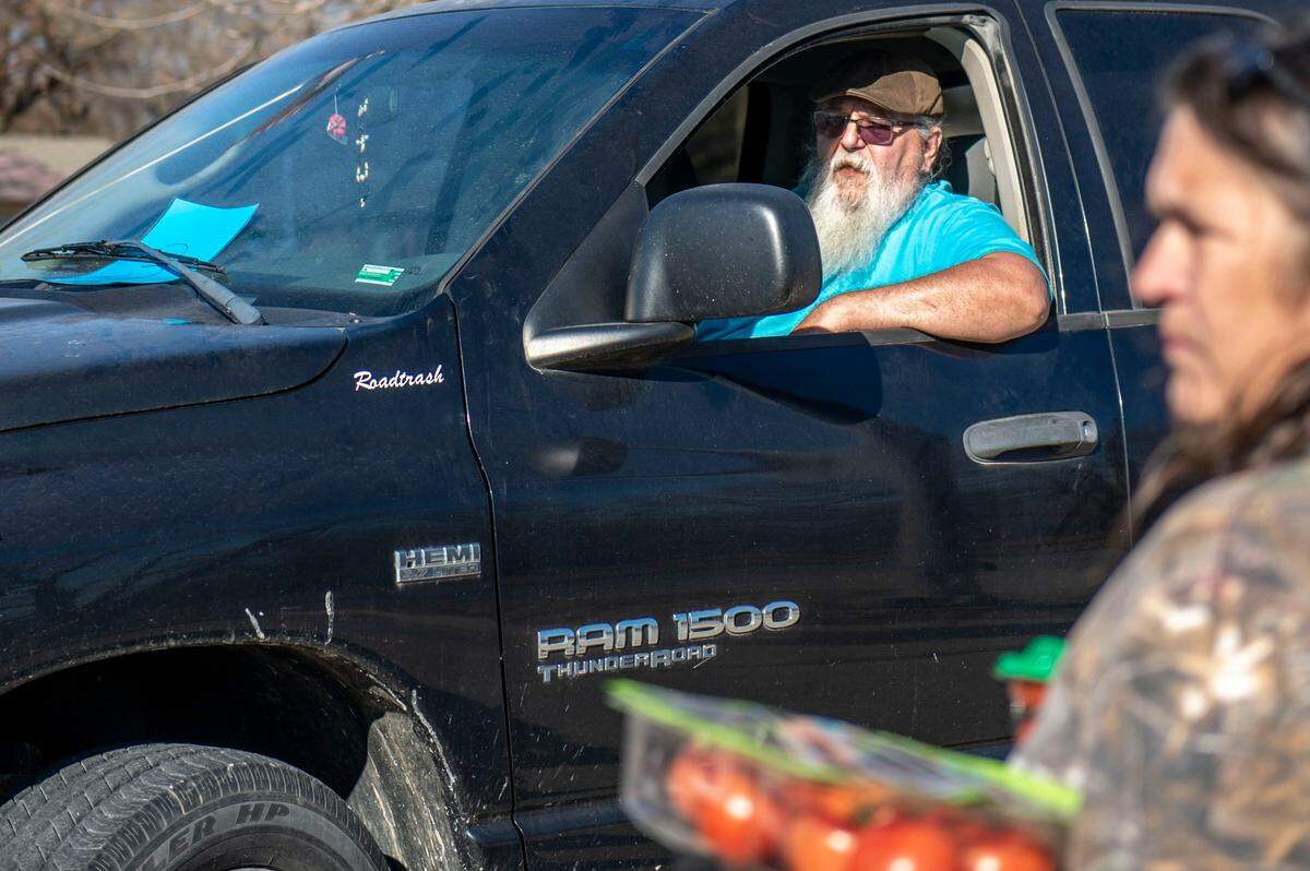Bill Adams drives up to a food pantry distribution at Deepwater City Hall on Dec. 6, 2021.